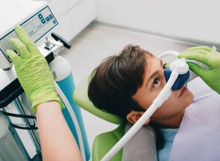 Child comfortably receiving gentle dental care with sedation in Montclair pediatric office